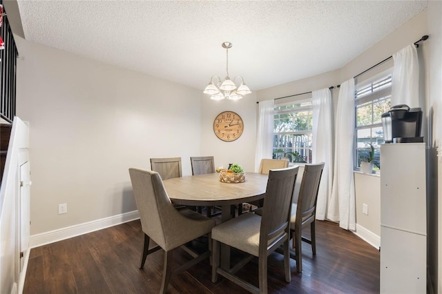 dining area with dark hardwood / wood-style floors, a chandelier, and a textured ceiling