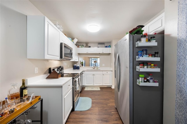 kitchen with stainless steel appliances, white cabinetry, sink, and dark hardwood / wood-style floors