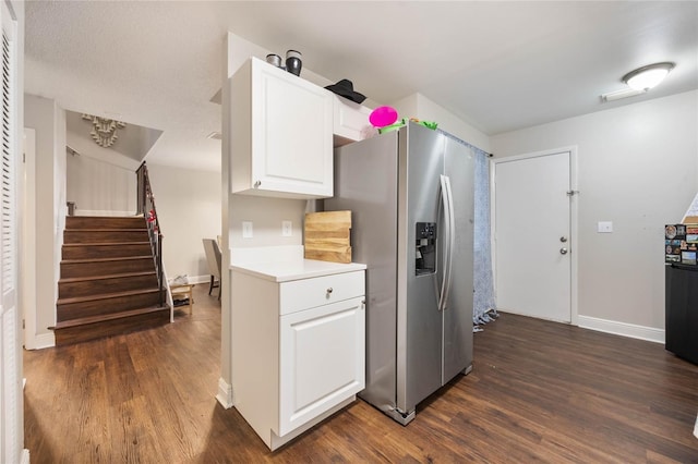 kitchen featuring stainless steel fridge with ice dispenser, dark wood-type flooring, and white cabinets