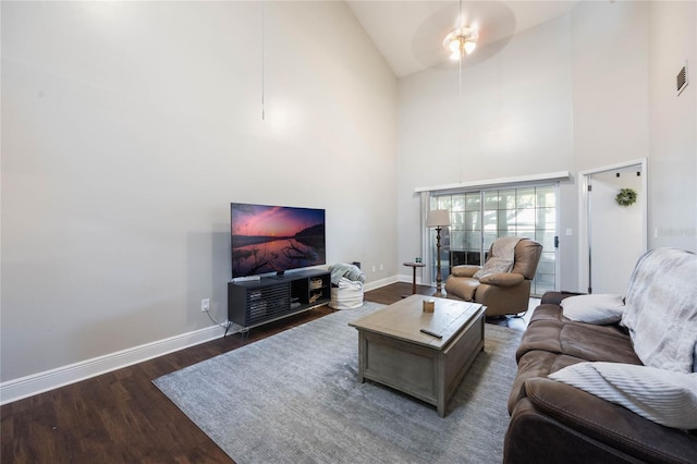 living room with ceiling fan, dark hardwood / wood-style flooring, and high vaulted ceiling