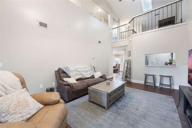 living room featuring a high ceiling and hardwood / wood-style floors