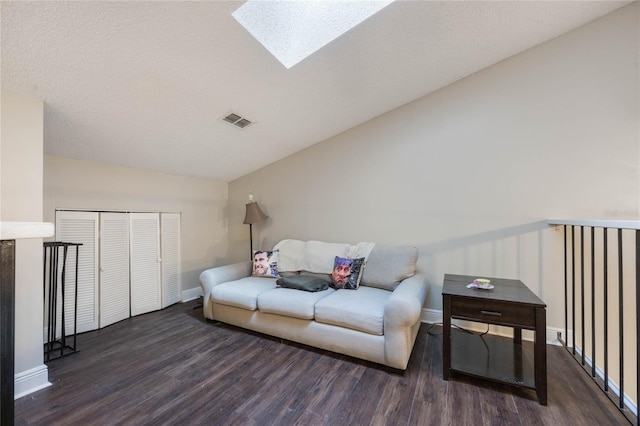 living room with lofted ceiling with skylight and dark hardwood / wood-style floors