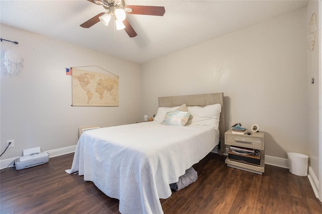 bedroom with dark hardwood / wood-style flooring and ceiling fan