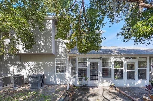 rear view of property with central AC unit