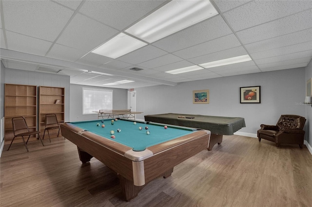 recreation room with a paneled ceiling, hardwood / wood-style floors, and billiards