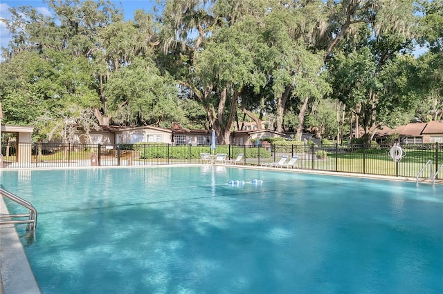 view of pool with a yard