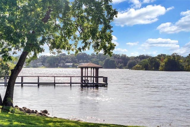 view of dock with a gazebo and a water view