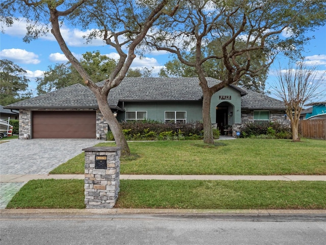 ranch-style house featuring a front yard and a garage