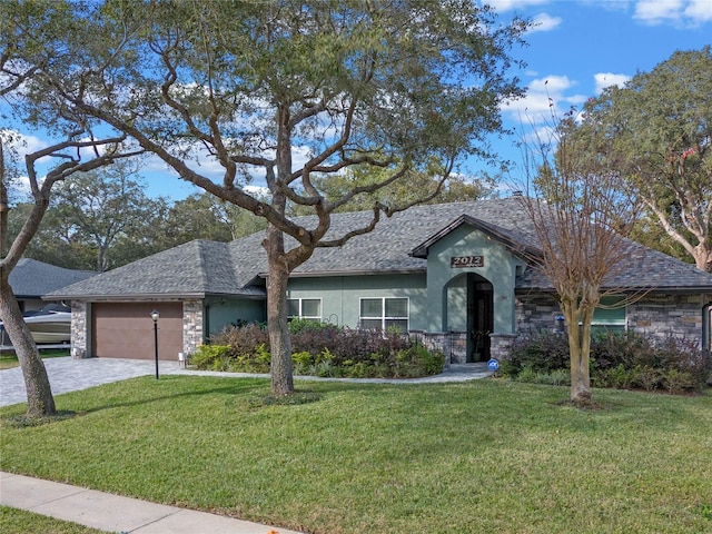 ranch-style home featuring a garage and a front lawn