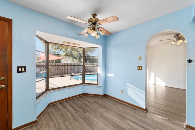 spare room with hardwood / wood-style floors and ceiling fan