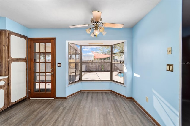 unfurnished dining area with hardwood / wood-style flooring and ceiling fan