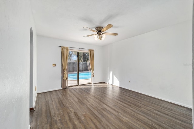unfurnished room featuring dark hardwood / wood-style floors and ceiling fan
