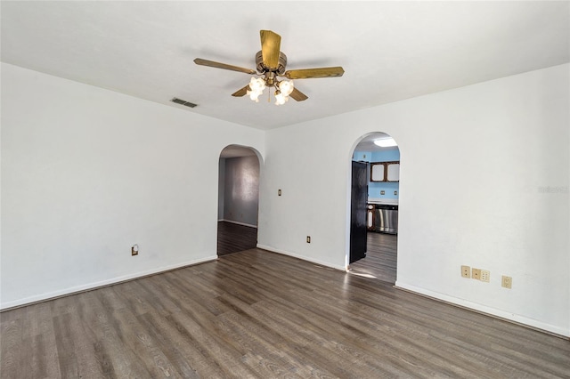 empty room with dark hardwood / wood-style floors and ceiling fan