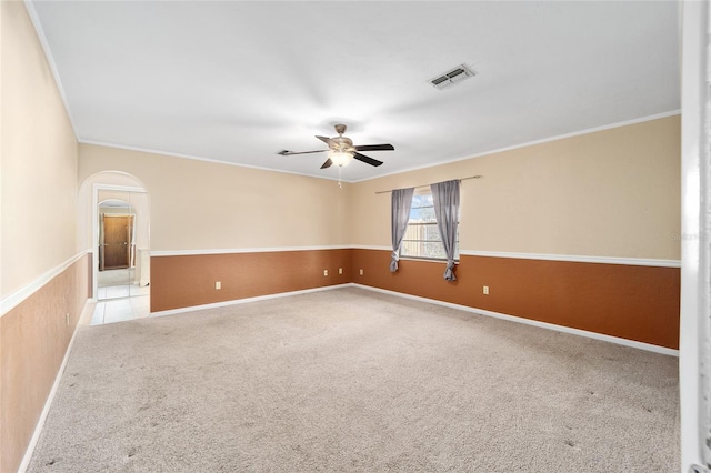 spare room with ornamental molding, light colored carpet, and ceiling fan