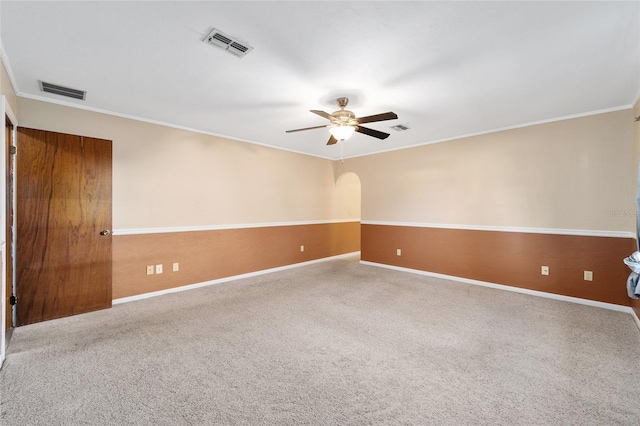 empty room featuring ornamental molding, carpet, and ceiling fan