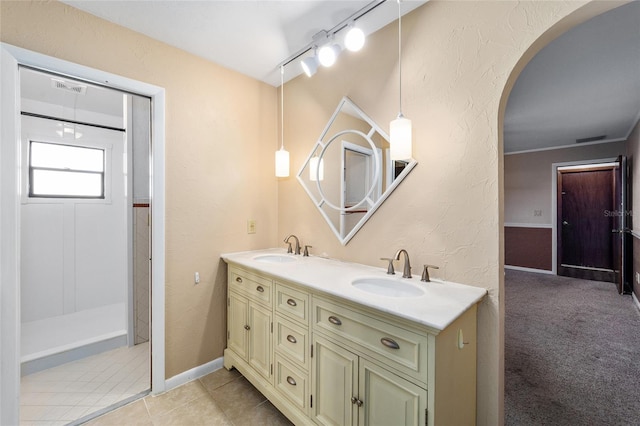 bathroom with vanity, tile patterned floors, and rail lighting