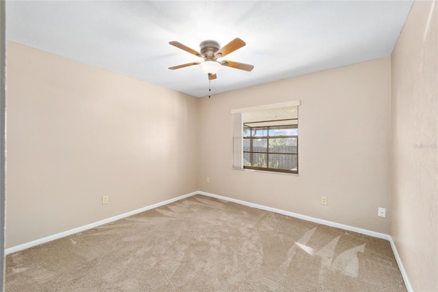 empty room with ceiling fan and carpet floors