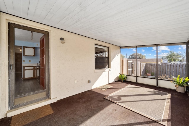 unfurnished sunroom featuring wood ceiling