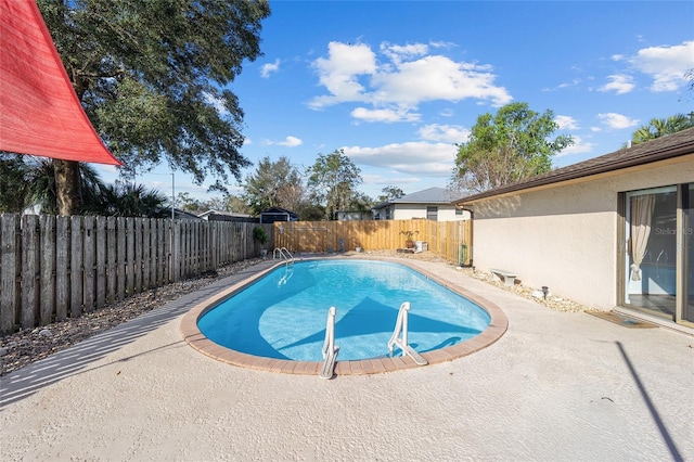 view of swimming pool with a patio area