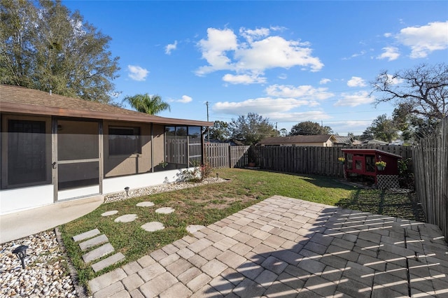 view of yard with a patio area and a sunroom