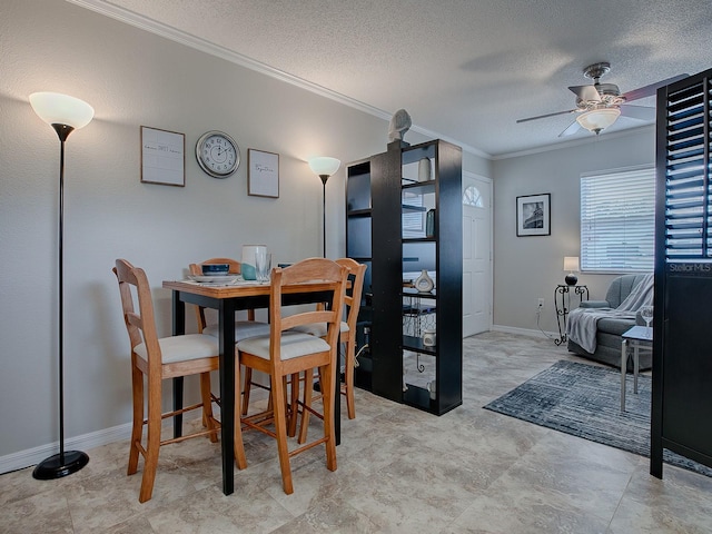 dining space featuring ceiling fan, ornamental molding, and a textured ceiling