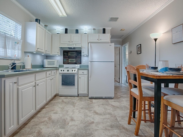 kitchen featuring sink, white cabinets, white appliances, and ornamental molding