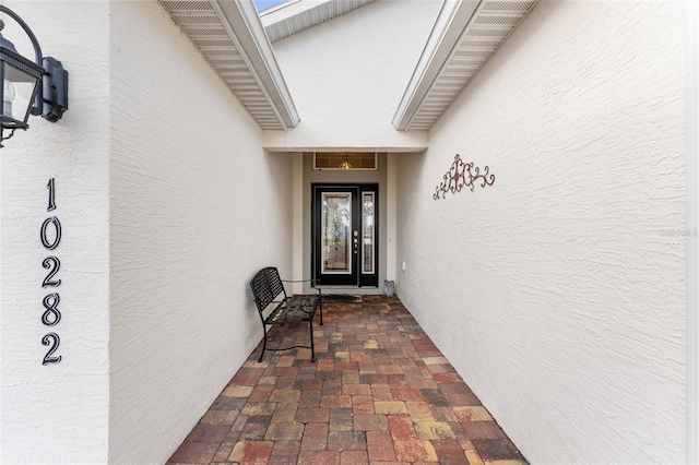 view of exterior entry featuring stucco siding