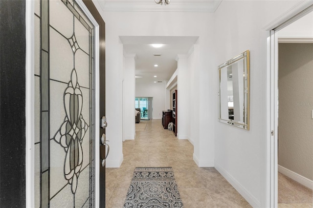 hallway with crown molding and light tile patterned flooring