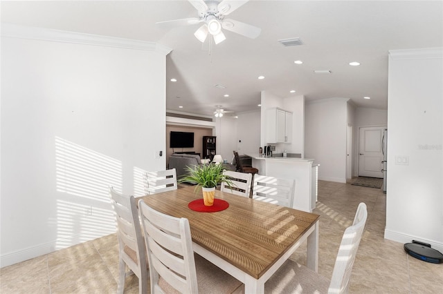 dining area with ceiling fan, light tile patterned flooring, and crown molding