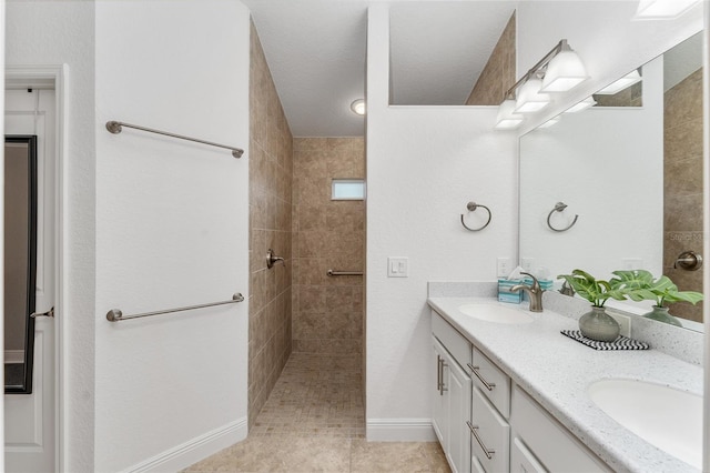 bathroom with vanity, tile patterned floors, and tiled shower