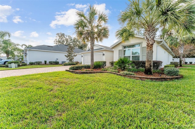 single story home featuring a garage and a front yard