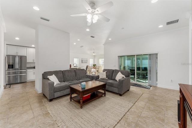 living room with ceiling fan and ornamental molding