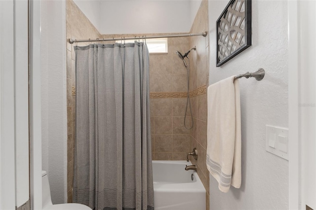 bathroom with toilet and shower / bath combo