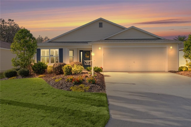 ranch-style home featuring a yard and a garage