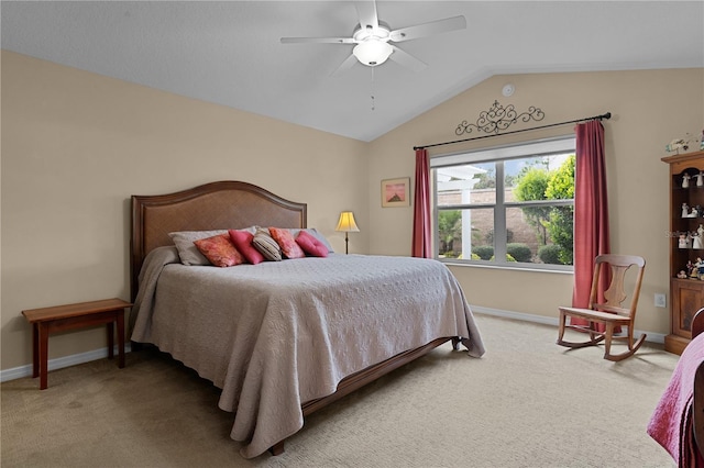 bedroom with ceiling fan, light colored carpet, and vaulted ceiling