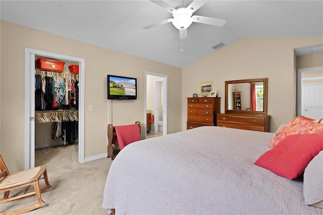 carpeted bedroom featuring a walk in closet, ensuite bathroom, ceiling fan, a closet, and lofted ceiling