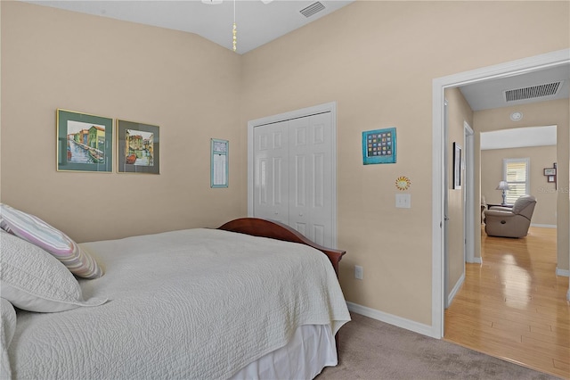 bedroom with light colored carpet and a closet