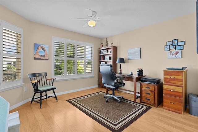 office area with ceiling fan, light hardwood / wood-style floors, and a textured ceiling