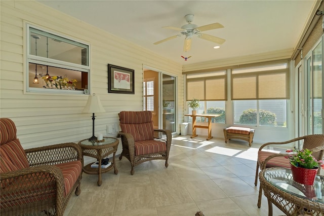 sunroom / solarium featuring ceiling fan