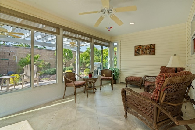 sunroom / solarium featuring ceiling fan