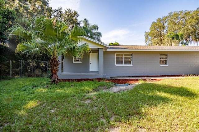 rear view of property with a lawn