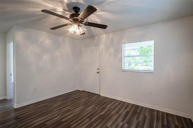 spare room featuring ceiling fan and dark hardwood / wood-style flooring