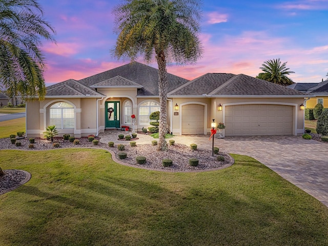 single story home featuring a yard and a garage