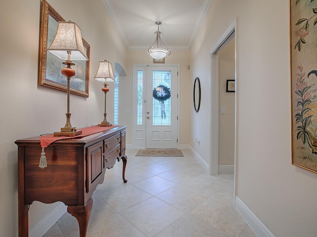 entryway with crown molding, baseboards, and light tile patterned floors