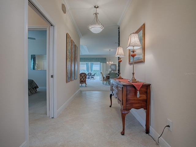 corridor featuring crown molding and a chandelier