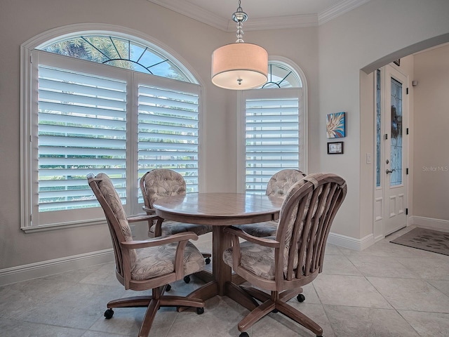 dining room featuring light tile patterned floors, a wealth of natural light, and crown molding