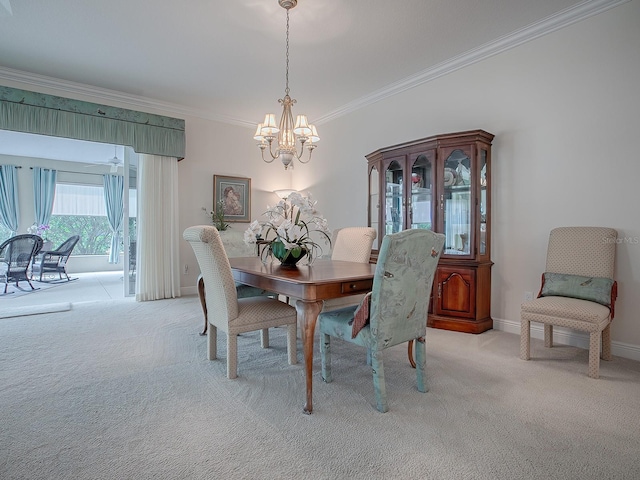 dining area with crown molding, an inviting chandelier, baseboards, and light colored carpet