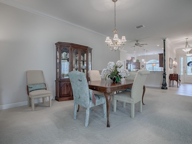 dining area with light carpet, ceiling fan with notable chandelier, and ornamental molding