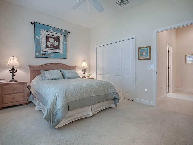 carpeted bedroom with baseboards, visible vents, ceiling fan, and a closet