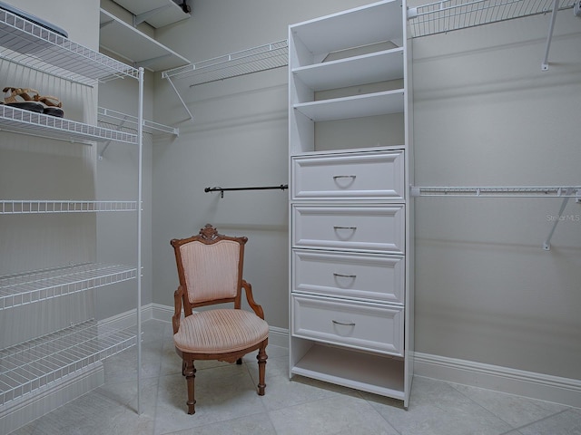 walk in closet featuring light tile patterned flooring